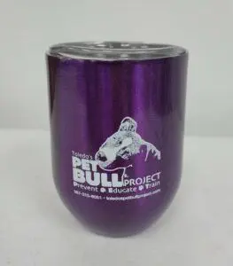 A purple cup with the pit bull project logo on it.