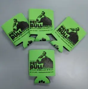 A group of five green can covers.