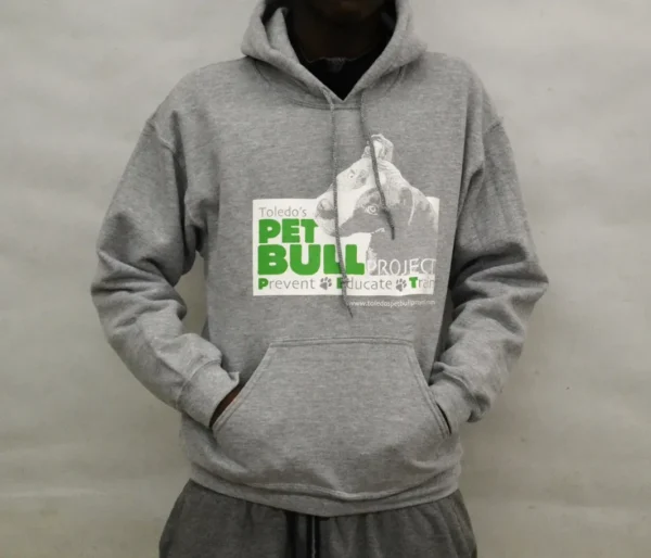 A person wearing a hoodie with the words " pet bull " on it.