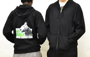 Two people wearing black hoodies with a cow on them.